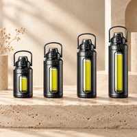Gourde en verre borosilicate NASH — quatre formats avec protection noire et poignée.
